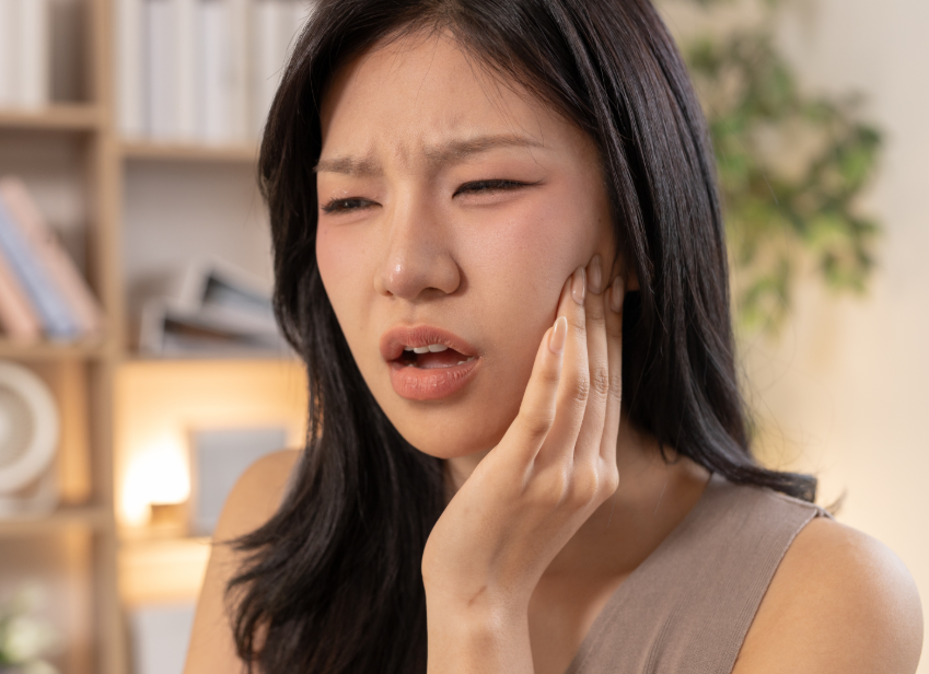Woman holding jaw in pain